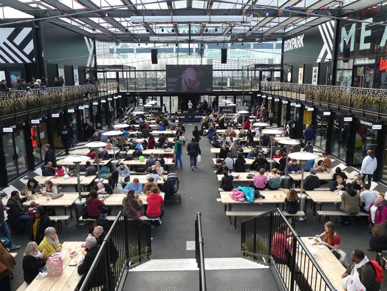 Interior shot of BoxPark in London featuring small businesses using containers