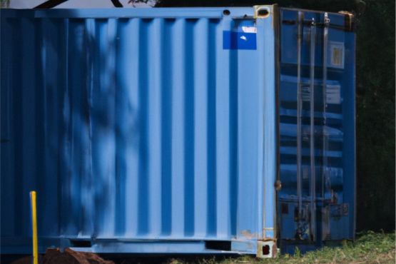 A blue shipping container keeping cool in the shade