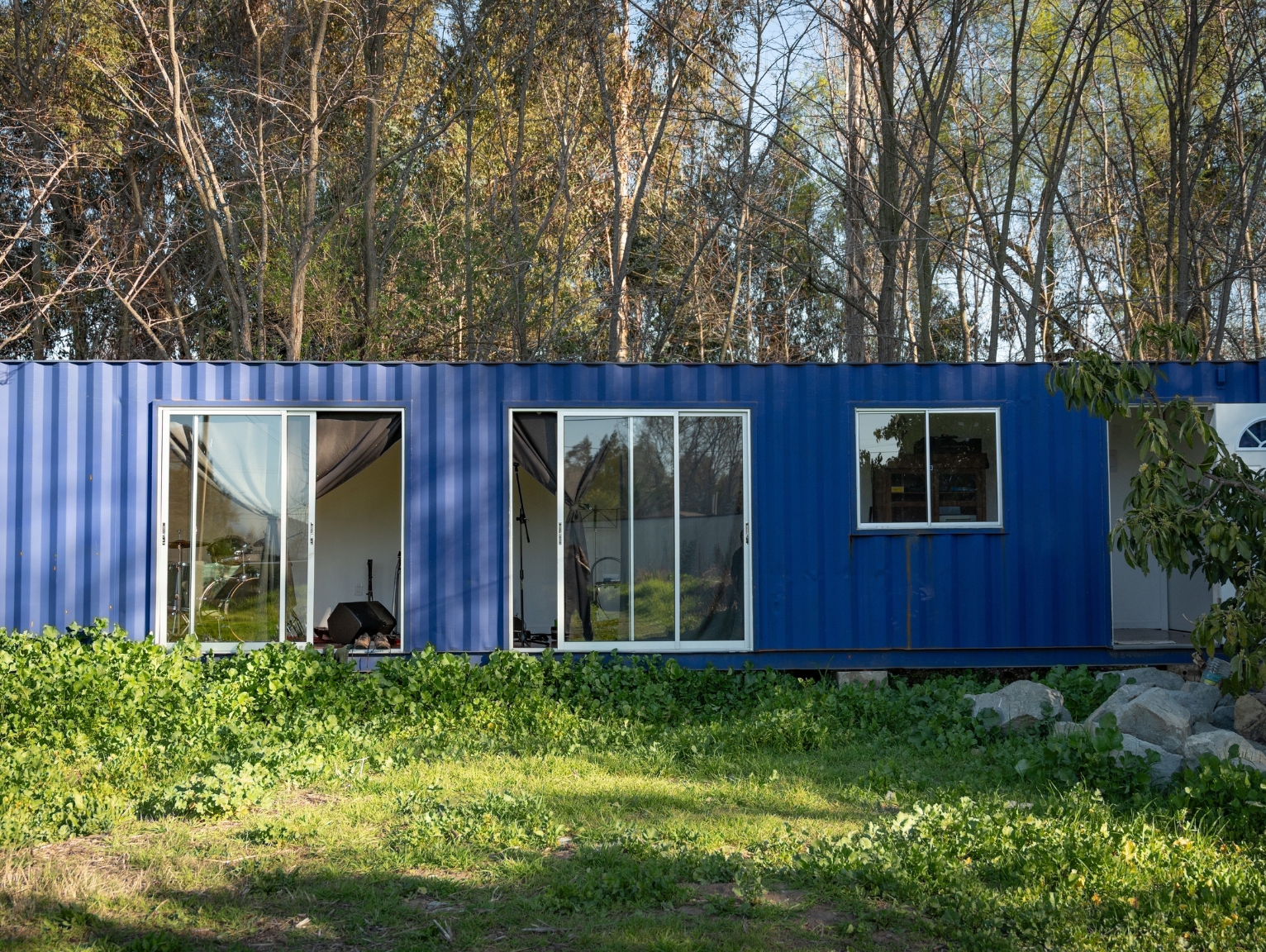 A blue shipping container chalet
