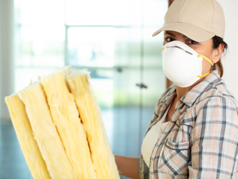 A builder carries insulation foam