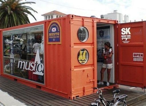 A shipping container retail store with a glass window