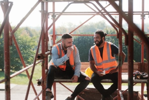 Two construction workers enjoying their lunch