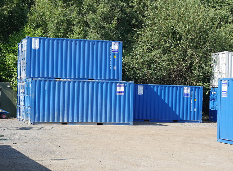 Three storage container boxes with two stacked and one standing alone