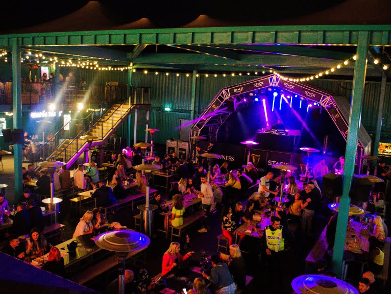An evening shot of STACK container bar/club in Seaburn featuring dancers and a DJ.