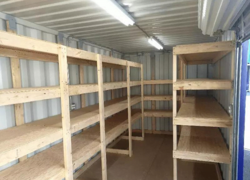 A shipping container tool shed with empty shelves ready to be filled with tools