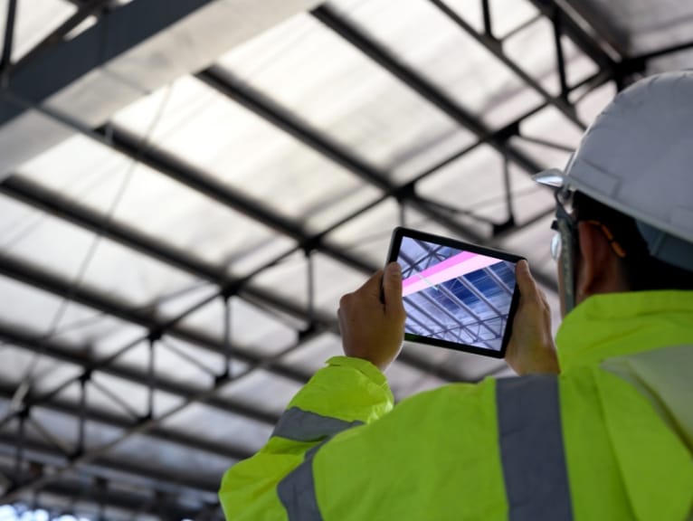 A construction worker uses 3d imaging