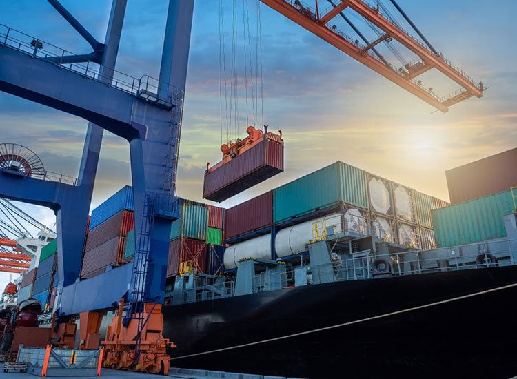 Different types of shipping containers being loaded on a ship