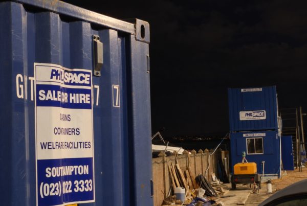 how-to-stop-tool-theft-on-construction-site: a blue philspace container on a southampton construction site at night in the uk
