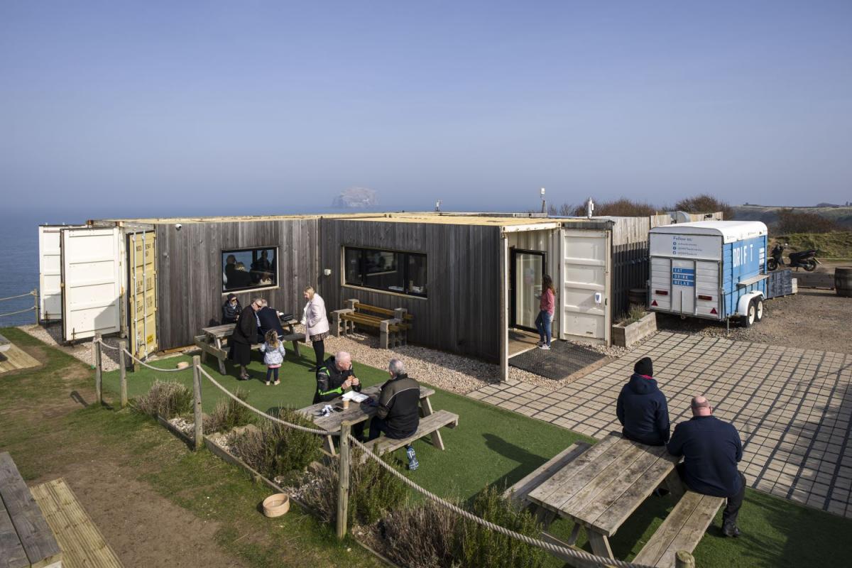 A cafe built out of shipping containers serving patrons