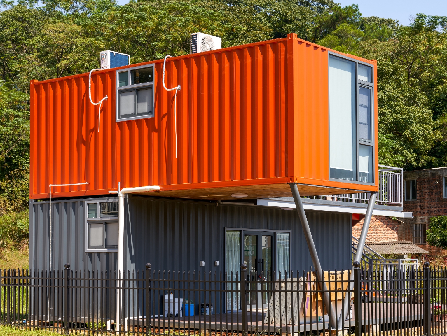 innovative uses for shipping containers: Converted shipping container building raised on supports, showing residential or commercial reuse of containers.