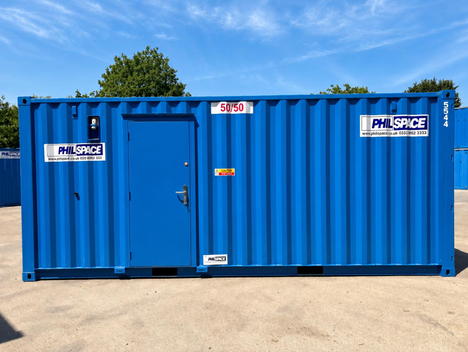 Is a 50 50 store right for your project — A blue shipping container conversion with a single door, branded with PhilSpace signage and a "50/50" label, set on a construction yard.