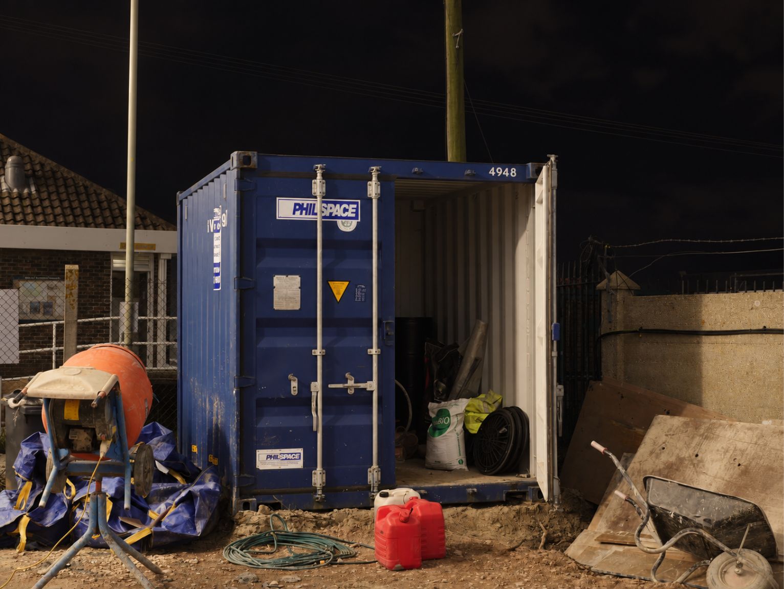 overnight-tool-storage-on-site: a philspace secure storage unit for tools on a UK construction site at night