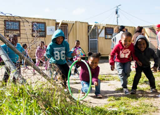 School Children playing shipping containers