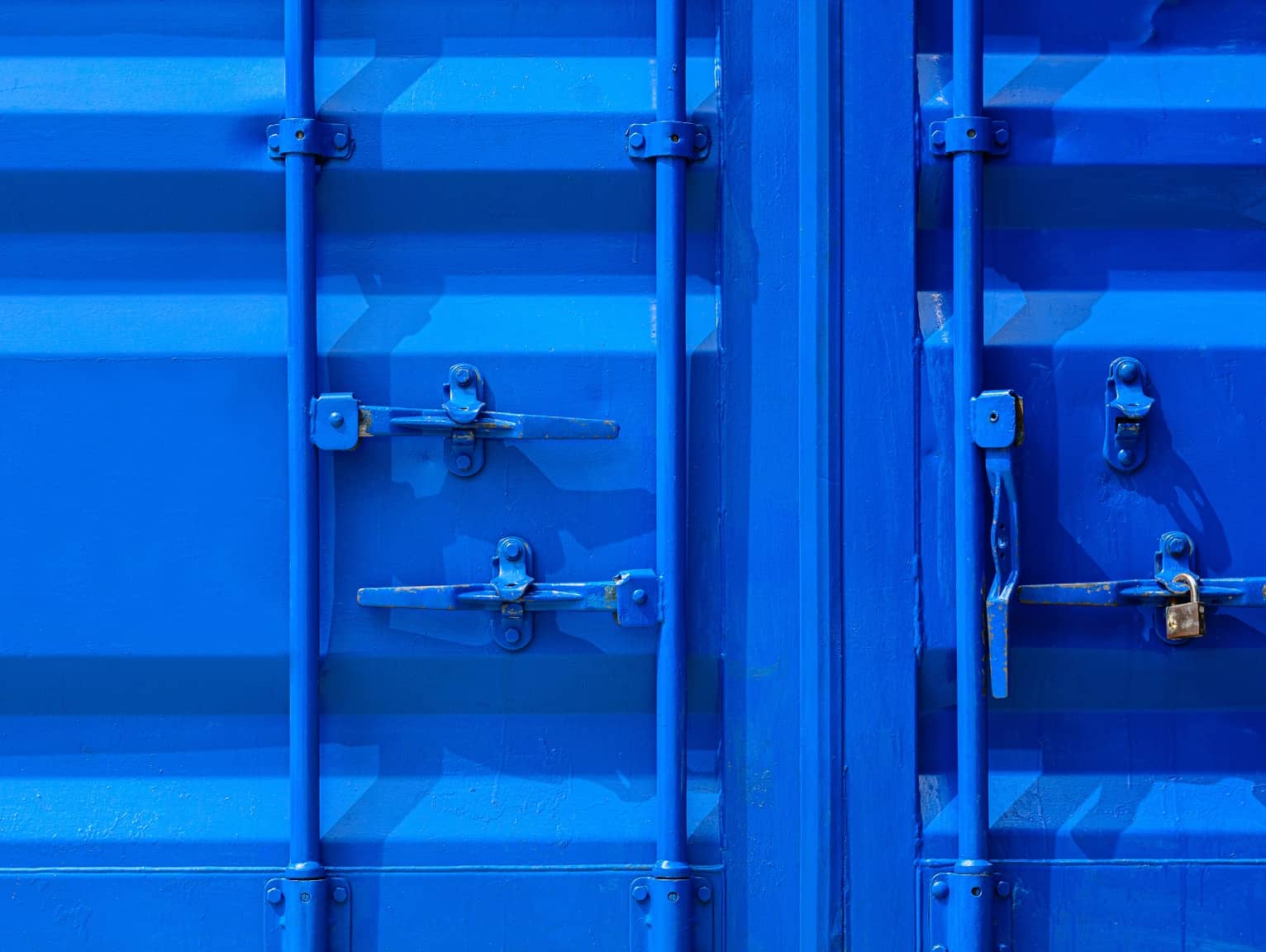 Close-up of locked blue shipping container doors