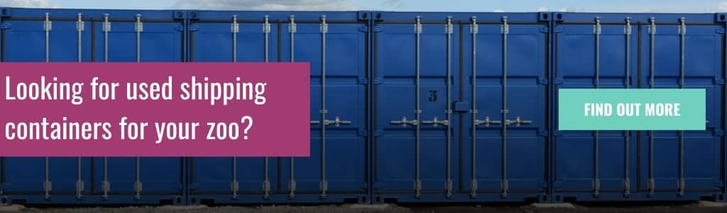 Row of blue shipping containers with advert asking about used shipping containers for zoos.